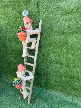 Couple climbing a ladder with a solar lamp